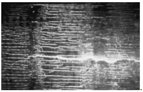 Box heat checking is shown in Figure 8, observed under black-light inspection.