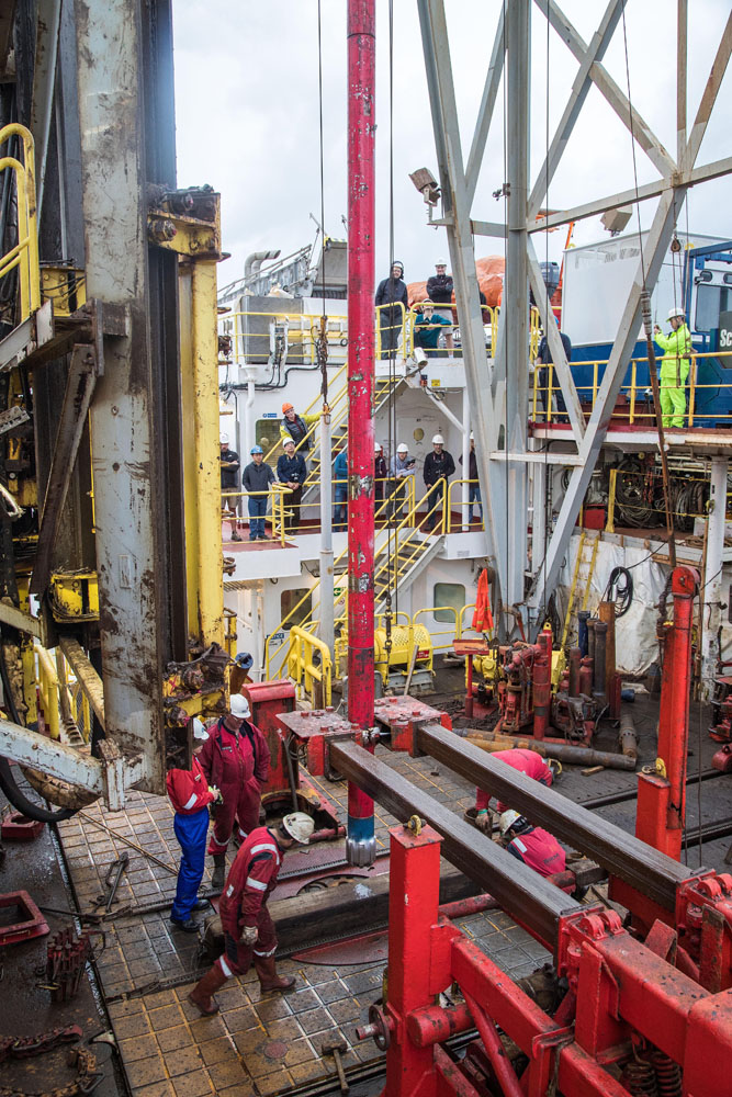 Two pipe-stabber arms positioning a vertical coring assembly for testing on JOIDES Resolution.